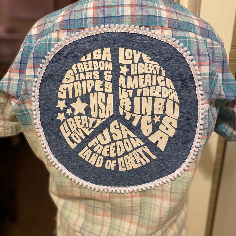 Upcycled blue plaid shirt with peace sign emblem